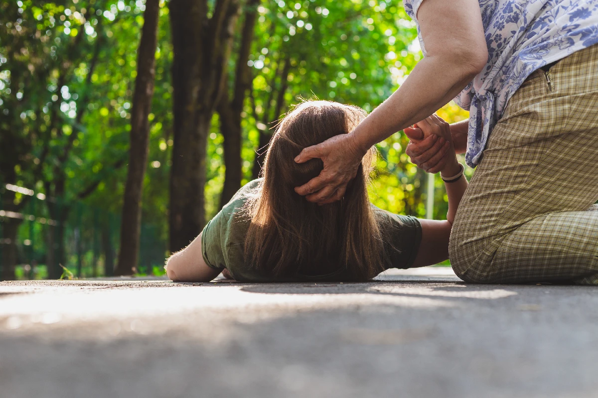 A person lying on the ground receiving care
